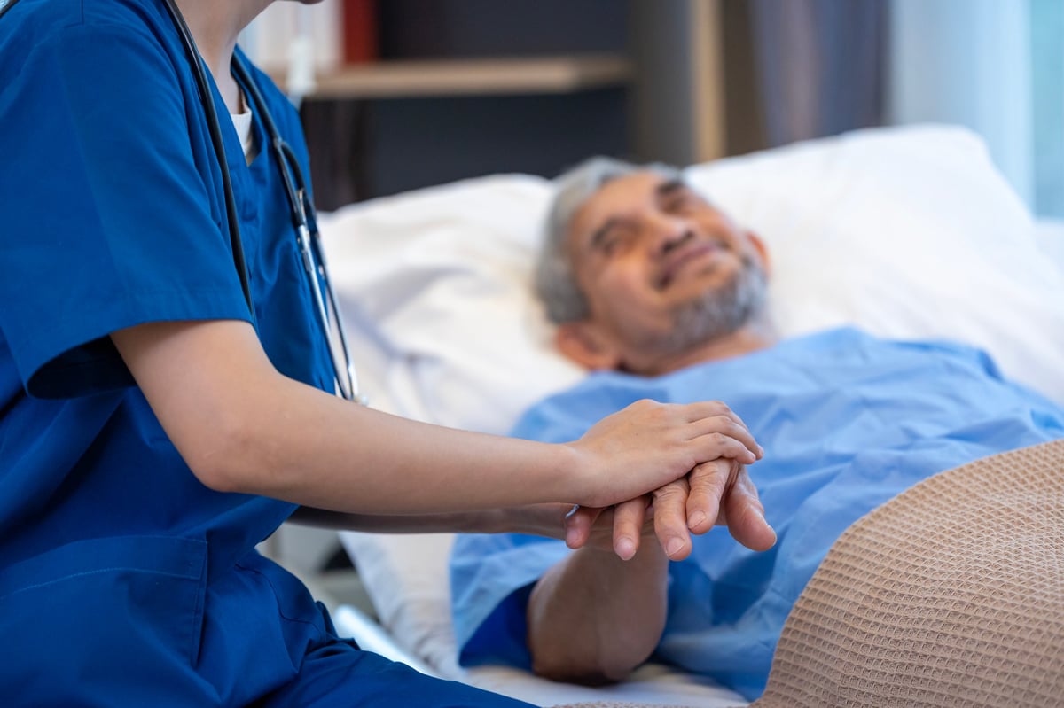 A senior patient receiving a medical service visit from a nurse
